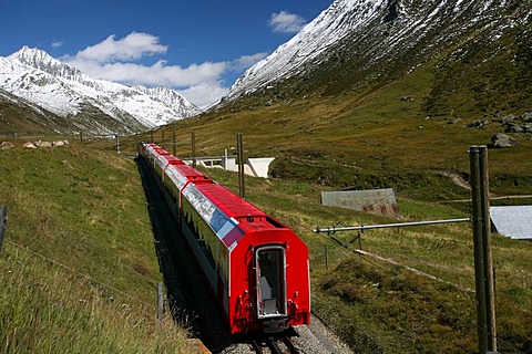 Cog railway section of the Matterhorn-Gotthardbahn (MGB) with red train coaches at the Oberalppass, Grisons/Uri, Switzerland