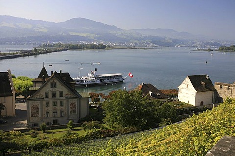 View from the castle hill to Lake Zurich and the isles of Ufenau and Luetzelau and tourist ships in the harbor of Rapperswil, St. Gall, Switzerland