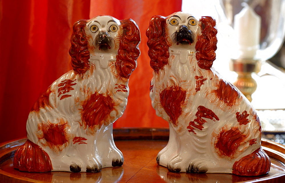 Two Cocker Spaniel porcelain figurines sitting on silver platter