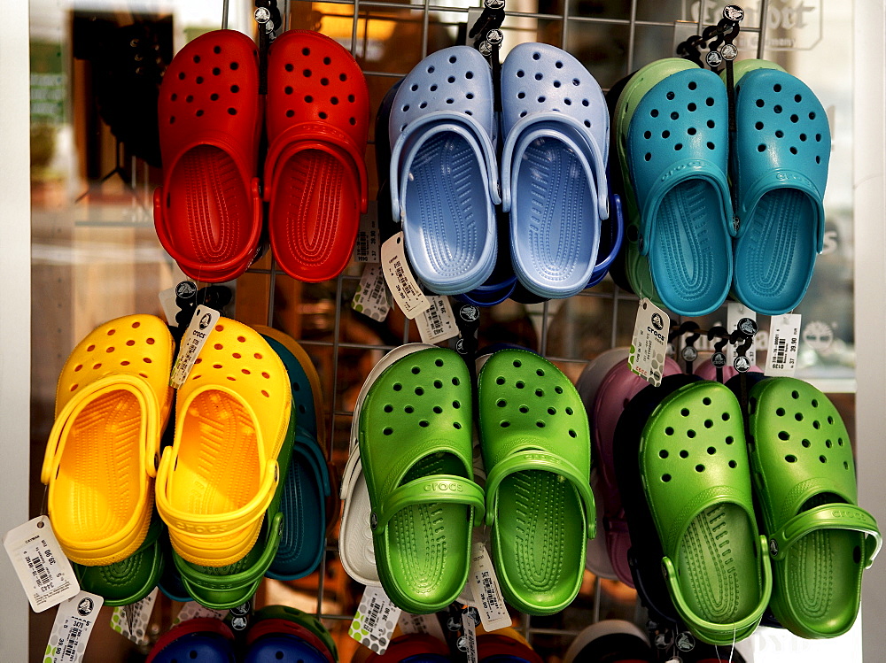 Brightly coloured plastic shoes on a grate, Lueneburg, Lower Saxony, Germany, Europe