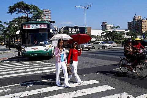 Two taiwanese women on the crosswalk in Taipei City, Taiwan