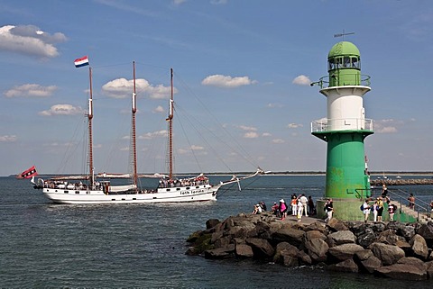 Three-masts Schooner named Loth LoriÃ«n next to the lighthouse of the Westmole, Hanse Sail 2008 in Warnemuende, Mecklenburg-Western Pomerania, Germany, Europe