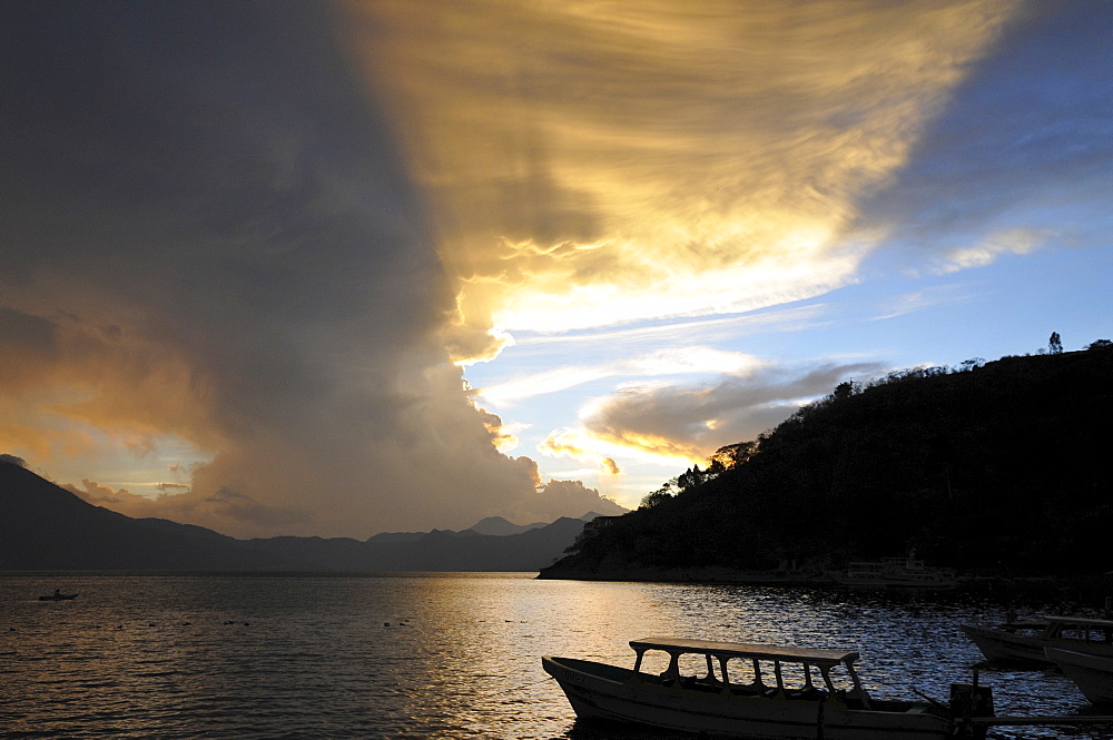 Sunset, back light, dramatic clouds, boat, Lake Atitlan, Guatemala, Central America