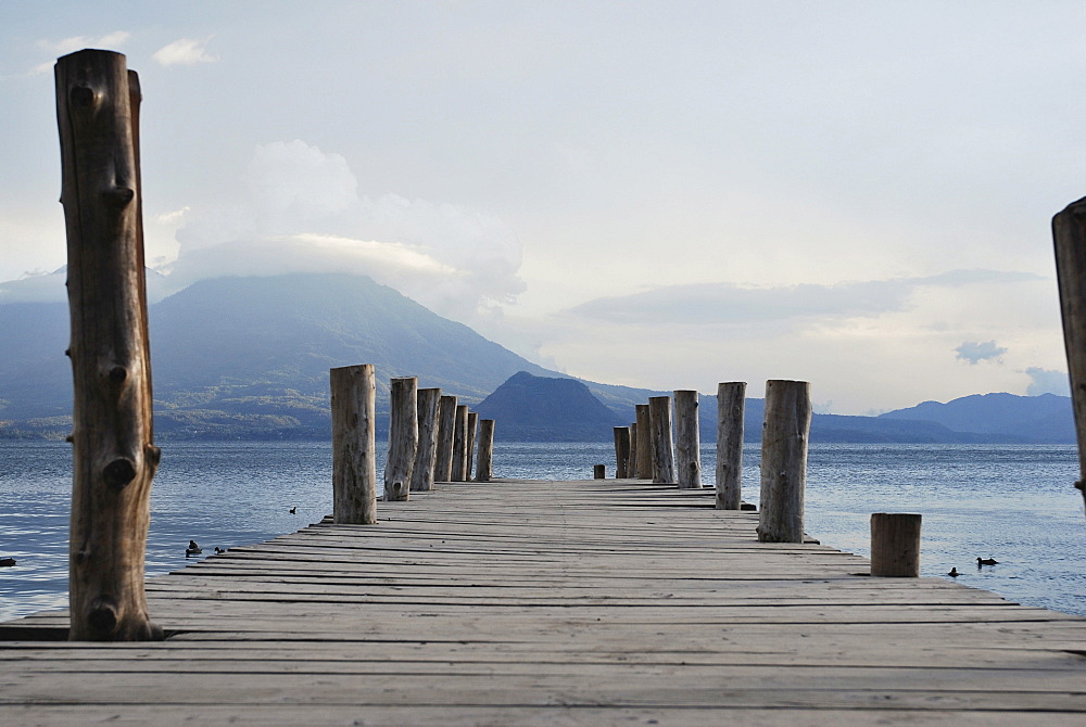 Wooden jetty, volcano, Lake Atitlan, Guatemala, Central America