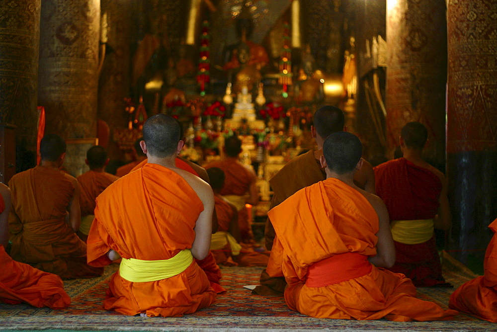 Evening prayer of the monks at temple Vat Xieng Thong in Luang Prabang, Laos