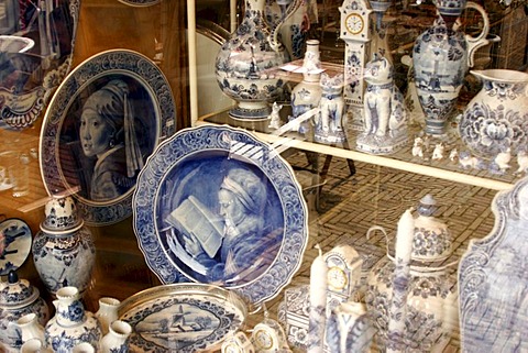 Art and kitsch as souvenirs from Delft . Delftware , or Delft pottery , is blue and white pottery traditionally made in and around Delft , the Netherlands