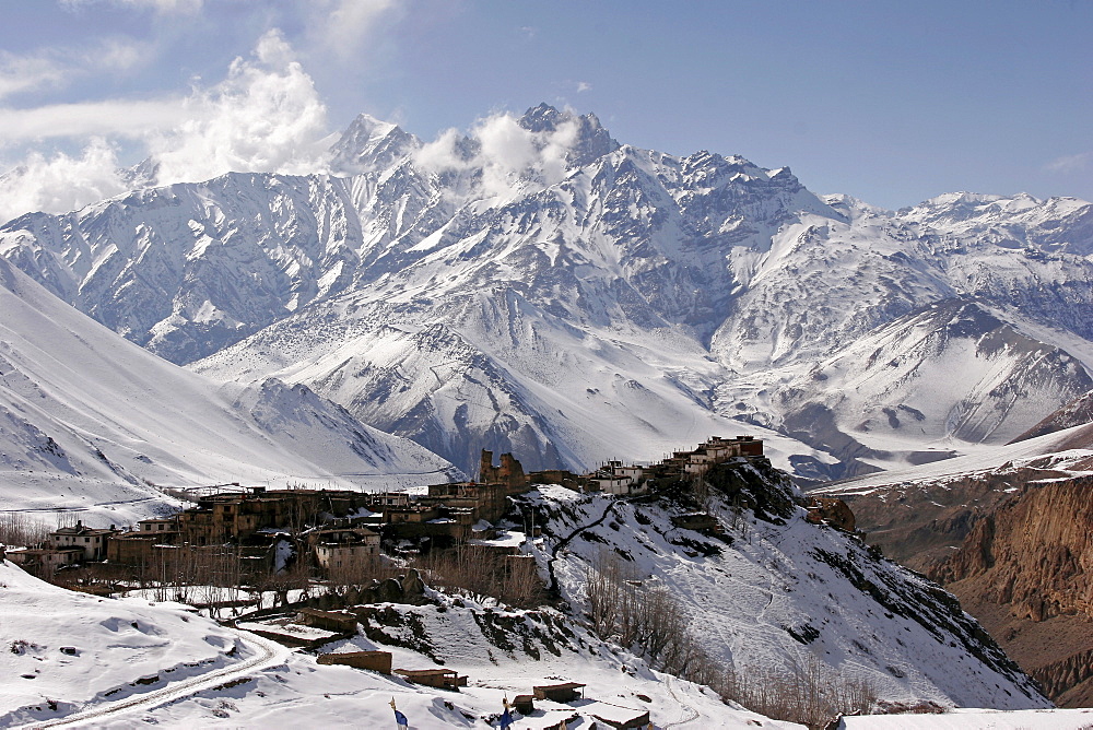 Dramatic scenery: the remote mountain village of Jharkot set against a backdrop of snow-covered mountains along the popular Jomsom Trail, Jharkot, Nepal, Asia