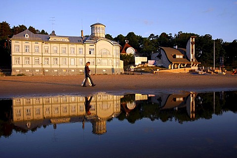 The former public swimming pool of E. Racene is reflected in the shallow water at the beach of Jurmala, Latvia, Baltic region, Europe