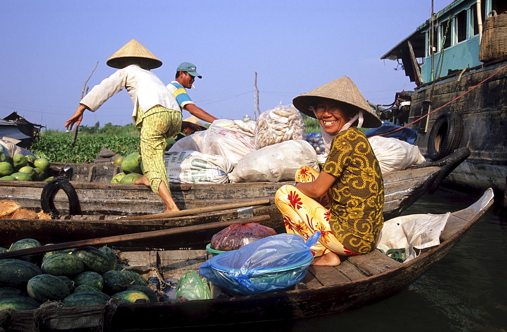 Laughing woman in a boat at the floating market in Long Xuyen, Mekong Delta, Vietnam, Asia