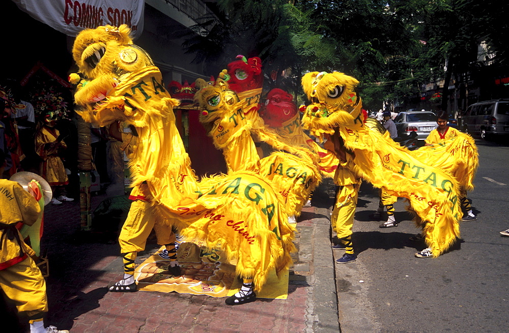 Dragon dance performed as part of the grand opening for a shop in Ho Chi Minh City, Vietnam, Asia