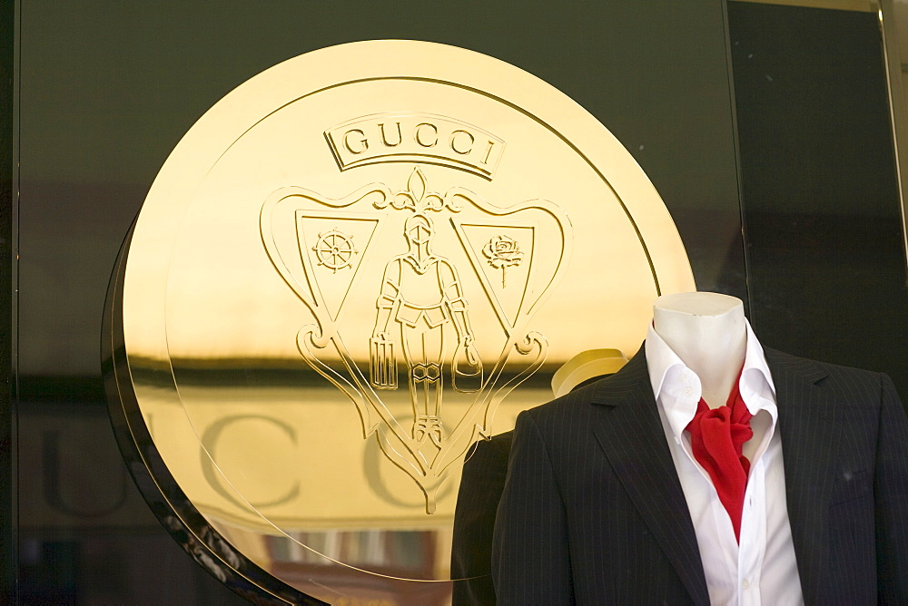 Gucci coat of arms behind a male mannequin in the window display of the Gucci fashion boutique on the Maximilianstrasse, Munich, Bavaria, Germany