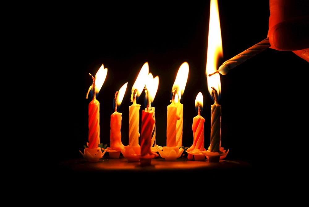 Lighting a candle on a birthday cake