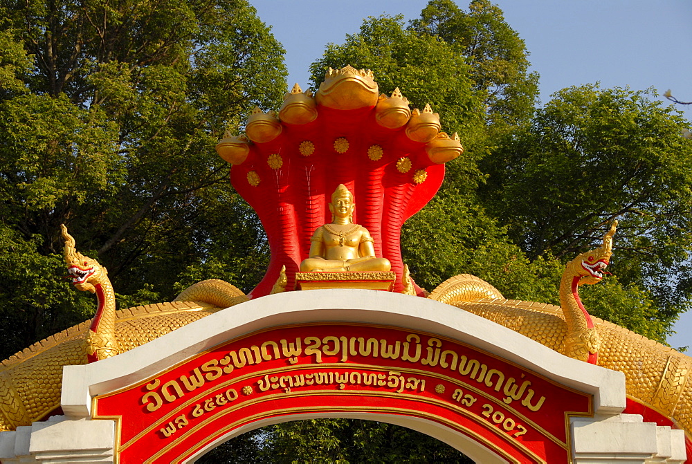 Entrance gate to the buddhist monastery Wat That Fune, decorated with golden snakes, Nagas, Vientiane, Laos, Asia