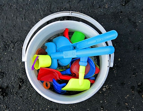 Little toy bucket with shovel and baking dishes