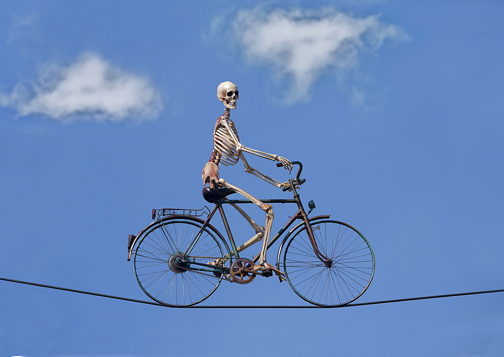 Sceleton rides bicycle on high-wire