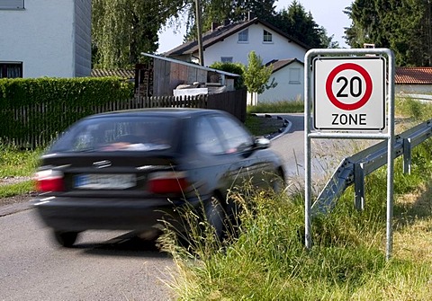 Markt Schwaben, GER, 26. June 2006 - A car passes a sign which marks the begin of a speed limited zone in Markt Schwaben Bavaria Germany.