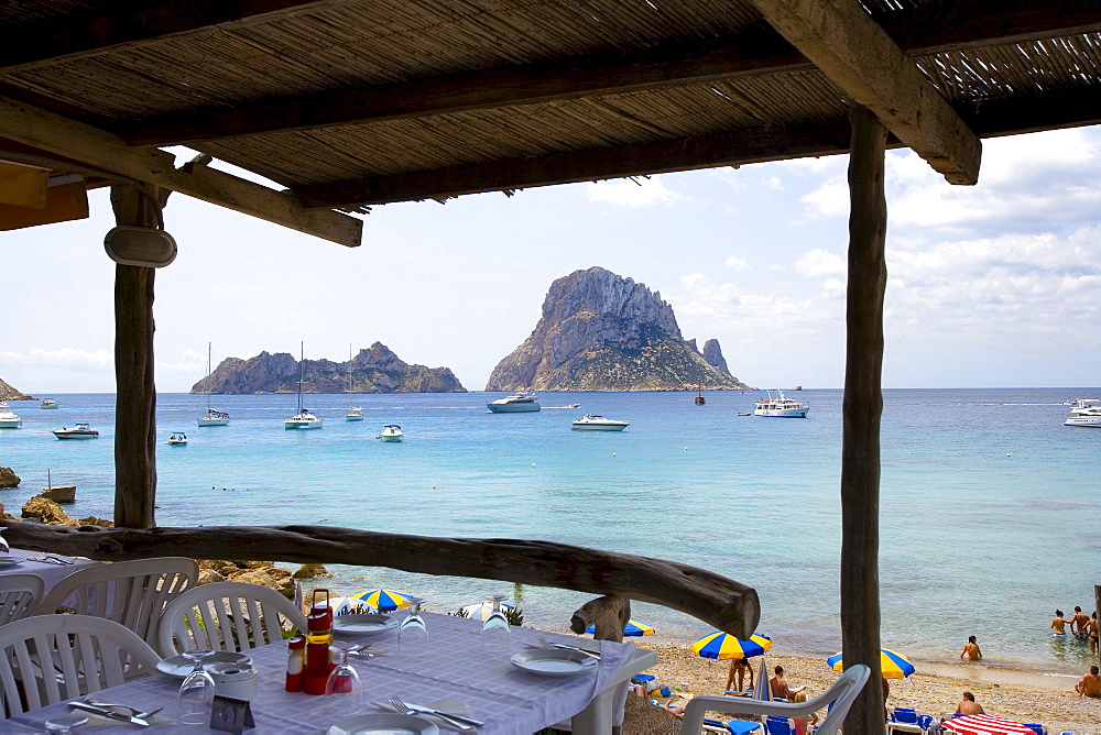 Beach restaurant in the bay of Cala dÂ¥Hort, view of rock island Es Vedra, Ibiza, Balearic Islands, Spain, Europe