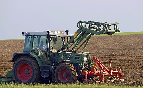 A tractor ploughs