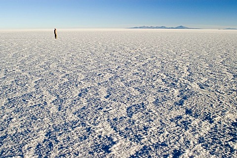 Person standing on Salar de Uyuni, Bolivia