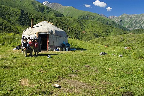 Family from Kyrgyzstan sitting in front of their yourt