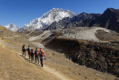 Trekking group on Khumbu glacier with Nuptse (7861), Khumbu Himal, Sagarmatha National Park, Nepal