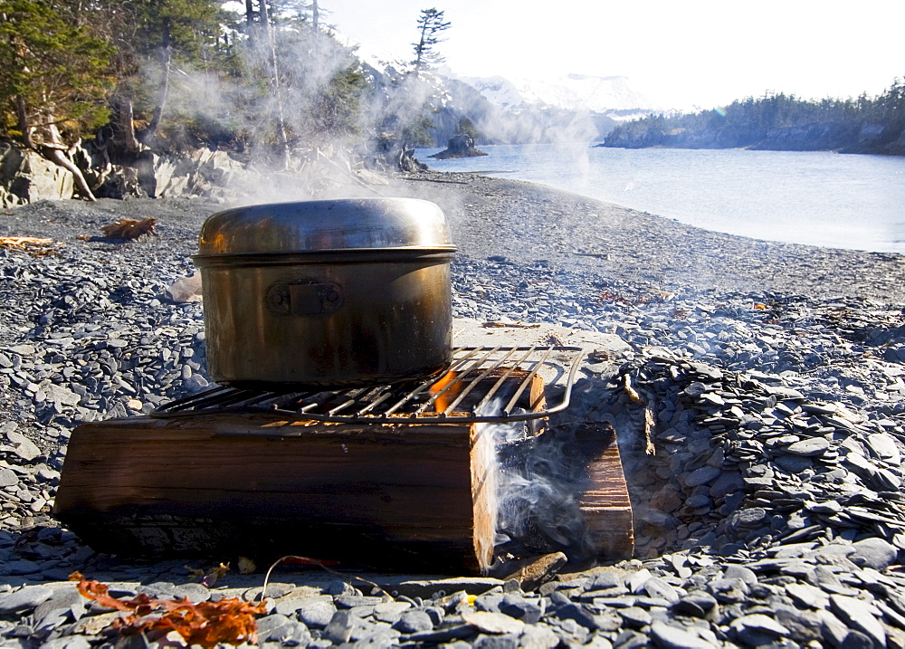 Steaming pot on a campfire, beach, evening, Pacific Coast, Prince William Sound, Alaska, USA