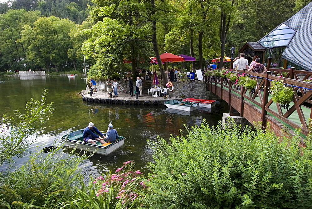 Swan lake in the spa Rajecke Teplice, promenading and rowboats, Slowakei