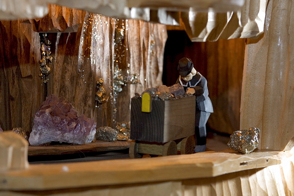 Hand carved miners in a christmas pyramid