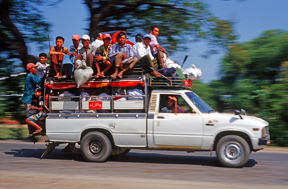 Overcrowded car, people on the roof, Burma, Asia