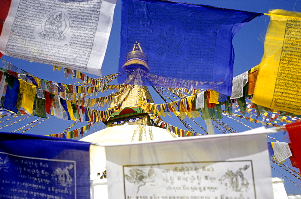 Prayer flags and view of the "all-seeing eyes of the Buddha, " Bodnath, Nepal, Asia