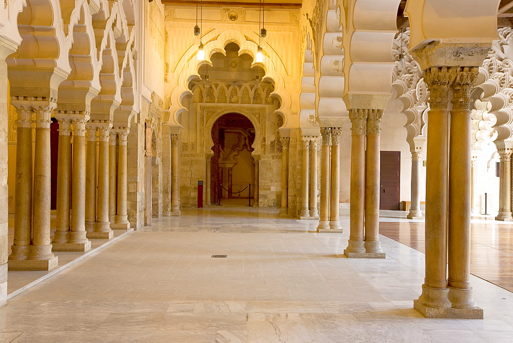 Ornate stone carved arched passageway of the Santa Isabel Patio, Palacio de Aljaferia palace, Moorish architecture, Zaragoza, Saragossa, Aragon, Spain