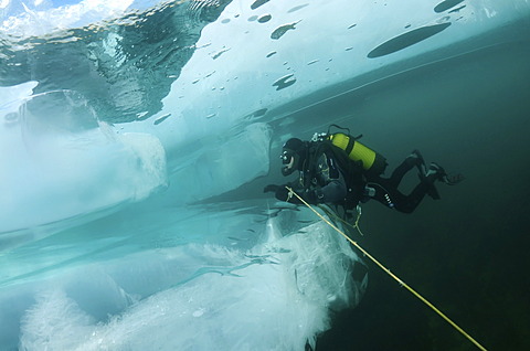 Diver, ice-diving, in Lake Baikal, Olkhon island, Siberia, Russia