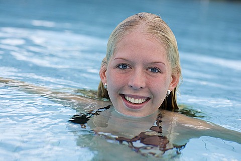 Portrait of laughing blond woman in the water