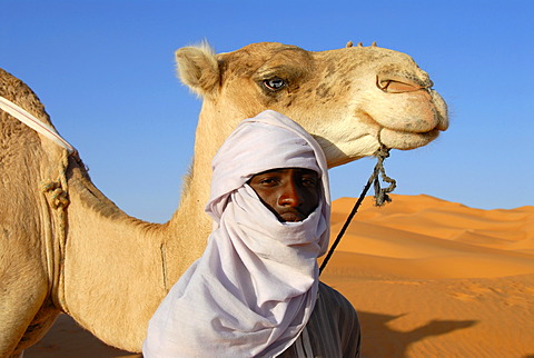 Tuareg with camel in sanddunes Mandara Libya