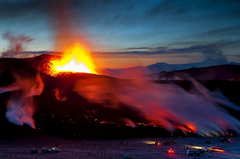 People with Super-Jeeps observing the lava flow from the eruption of the FimmvoerâˆšâˆžuhâˆšÂ°ls Volcano, between MâˆšÎ©rdalsjoekull and Eyjafjallajoekull, Highland, Iceland, Europe