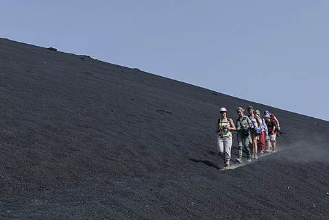 Hikers in the ash field of the Pico do Fogo volcano, Fogo National Park, Fogo island, Cape Verde