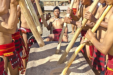 Members of the Samdom tribe show their traditional way of crushing crops at the annual Hornbill Festival, Kohima, Nagaland, India, Asia