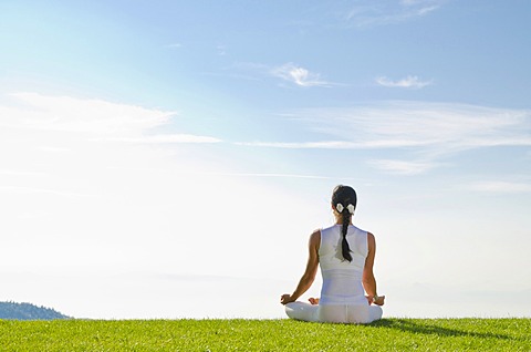 Young woman practising Hatha yoga outdoors, showing the pose padmasana, lotus pose, Nove Mesto, Okres Teplice, Czech Republic, Europe