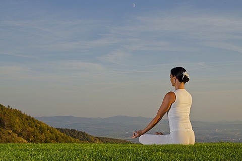 Young woman practising Hatha yoga outdoors, showing the pose padmasana, lotus pose, Nove Mesto, Okres Teplice, Czech Republik, Europe