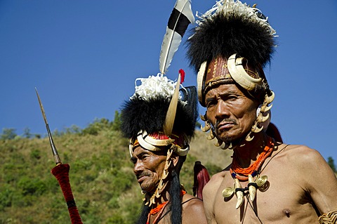 Warriors of the Konyak tribe waiting to perform ritual dances at the Hornbill Festival, Kohima, Nagaland, India, Asia