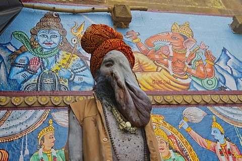 Physically disabled Sadhu, holy man, at one of the ghats of the historic city of Varanasi, India, Asia