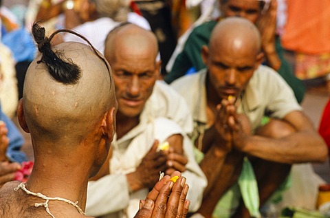 A priest is supporting a praying ritual for the good reincarnation of a dead person at Har Ki Pauri Ghat in Haridwar, Uttarakhand, formerly Uttaranchal, India, Asia