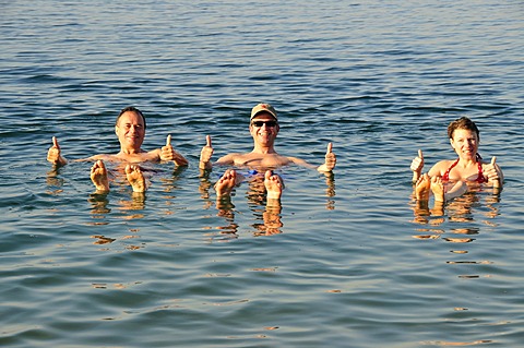 Tourists, thumbs-up, in the Dead Sea near Suwaymah, Jordan, Middle East, Orient