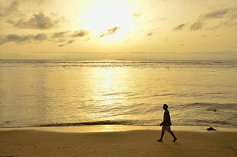 Man walking along a beach at sunset, near Kribi, Cameroon, Central Africa, Africa