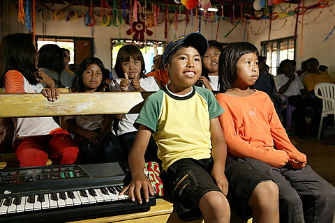 Indian children sitting next to an e-piano, Loma Plata, Chaco, Paraguay, South America