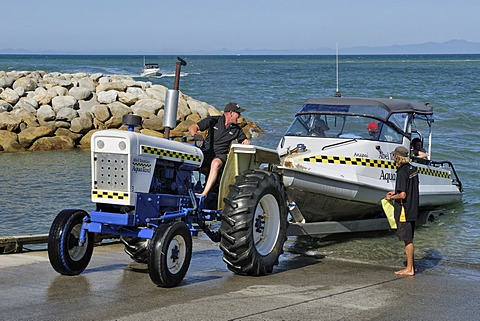 Water taxi with tourists being pulled ashore, Marahau, Tasman Bay, South Island, New Zealand