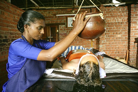 Shirodhara, gently pouring oils over the forehead (the \'third eye\'), Somatheeram Ayurveda Resort, traditional Ayurvedic medicine spa resort in Trivandrum, Kerala, India, Asia