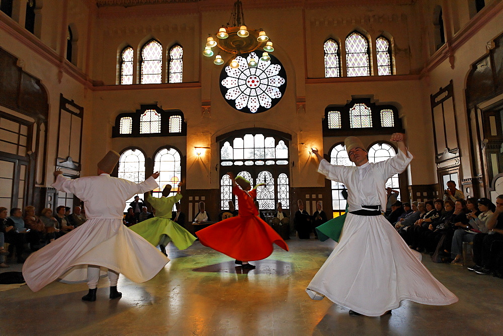 Dancing dervishes of the Sufi order Mevlevi, Sema ceremony, historic train station Sirkeci, Istanbul, Turkey