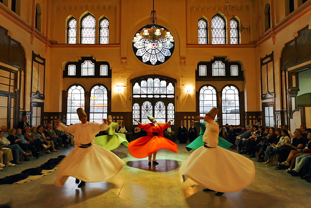 Dancing dervishes of the Sufi order Mevlevi, Sema ceremony, historic train station Sirkeci, Istanbul, Turkey