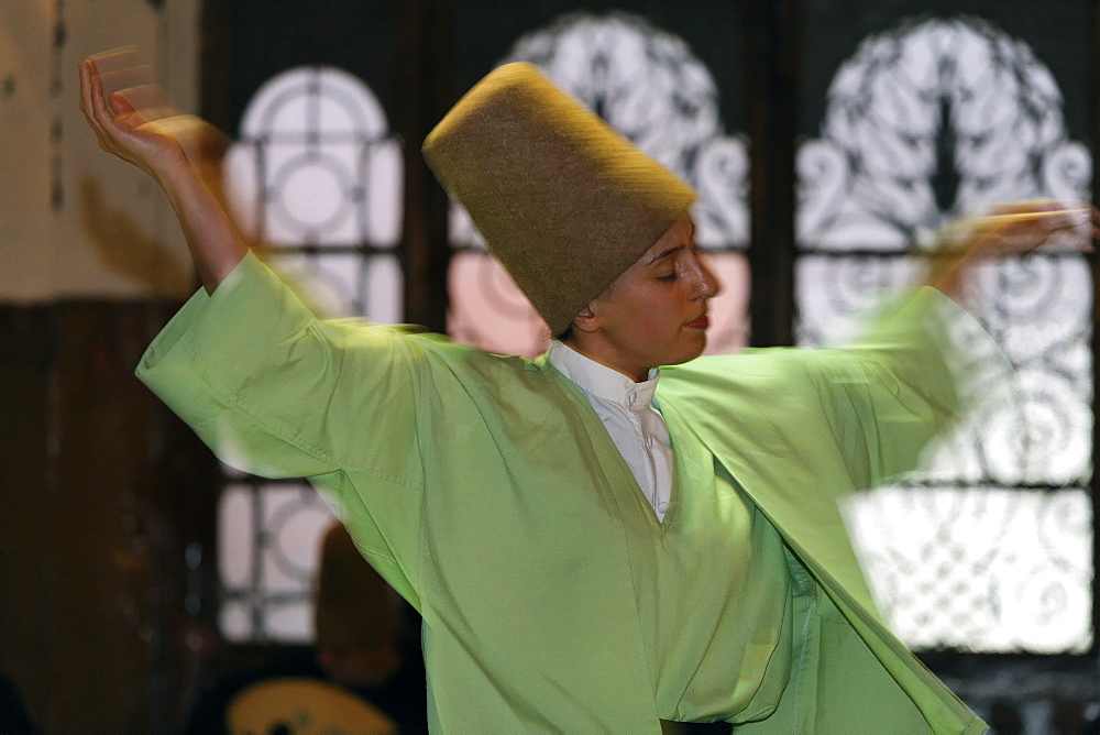 Female dancing dervish from the Sufi order Mevlevi, Sema ceremony, historic train station Sirkeci, Istanbul, Turkey